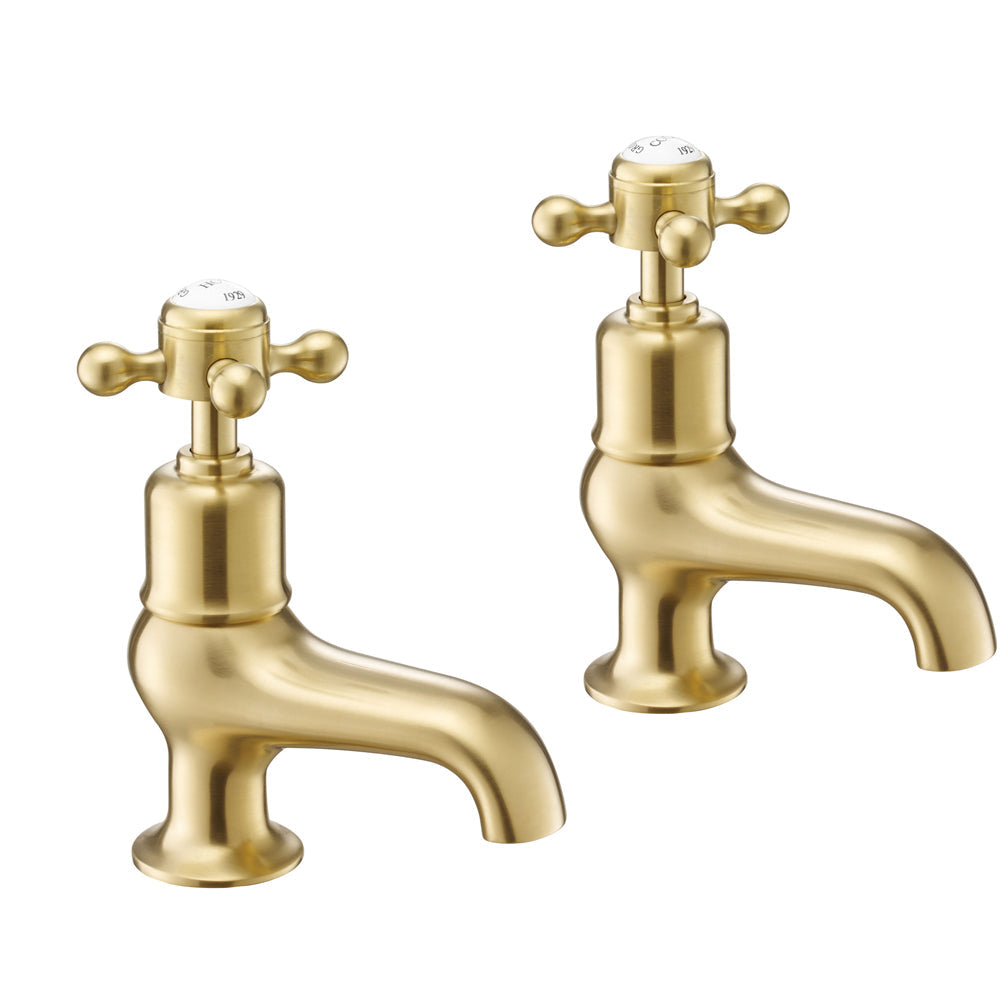 Deck-mounted brushed brass pillar bath tap