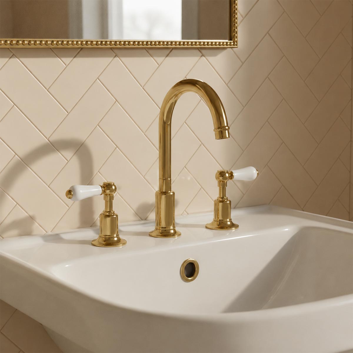 A three-hole bathroom tap set in polished gold with white ceramic handles