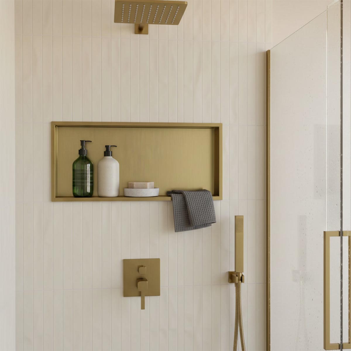Gold bathroom shower niche with a rectangular framed shelf
