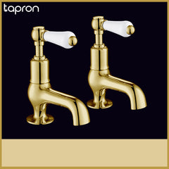Antique brass pillar tap with white ceramic accent lever handle