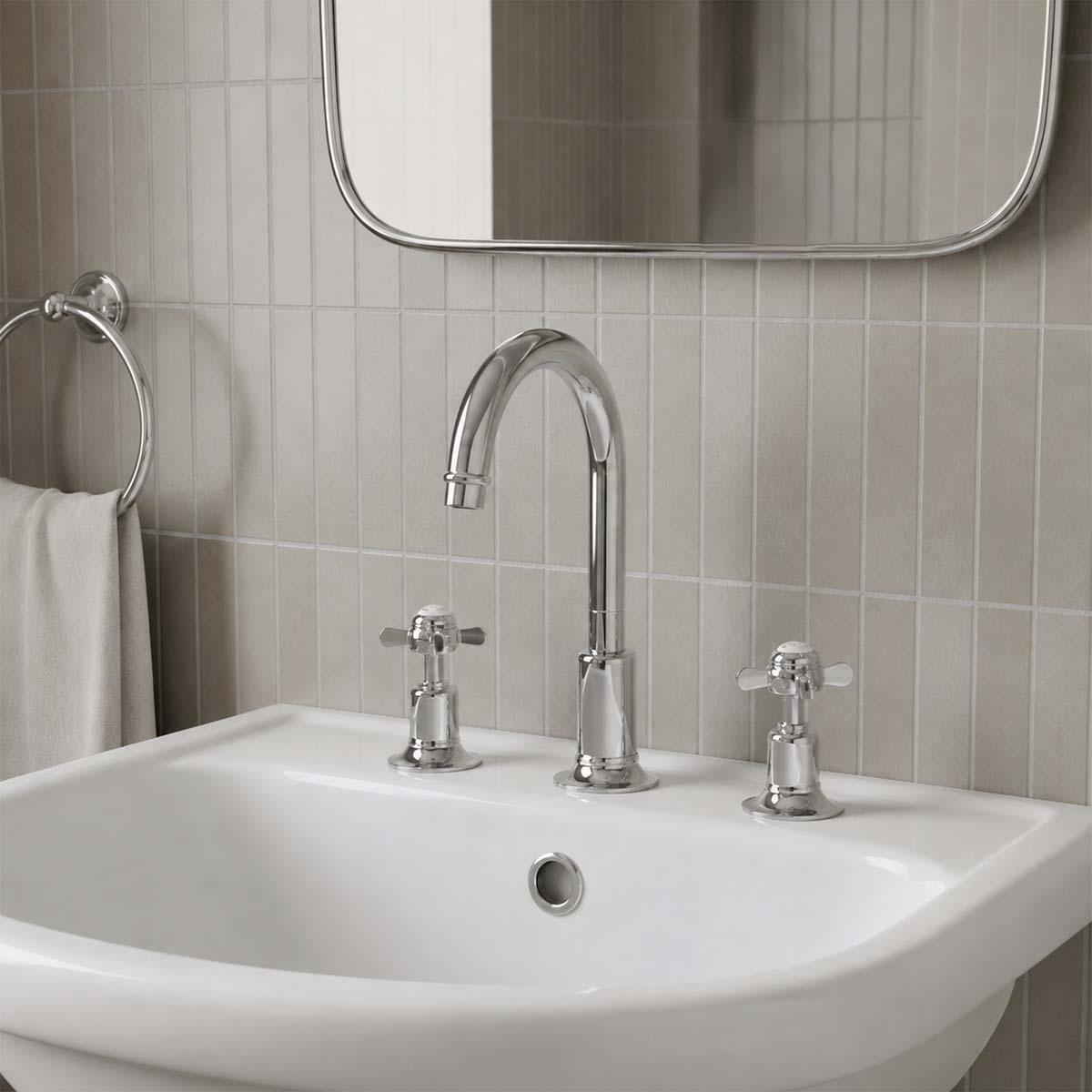Traditional three-hole bathroom faucet set with a polished chrome gooseneck spout and two matching crosshead handles