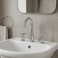 Traditional three-hole bathroom faucet set with a polished chrome gooseneck spout and two matching crosshead handles