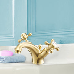 Gold bathroom sink tap with pop-up waste