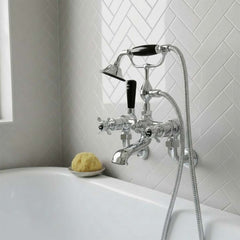 chrome bathtub tap set with a handheld shower hose, mounted on a white tiled wall