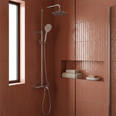 chrome rain shower head, handheld shower attachment, and control valve in a modern shower system