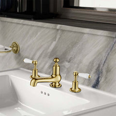 Antique brass basin tap with white ceramic accent dual lever handle