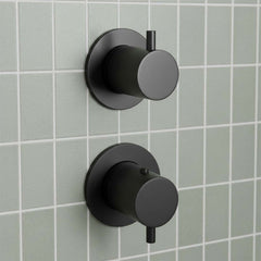 matt black wall-mounted thermostatic  shower valves with circular knobs and small lever handles