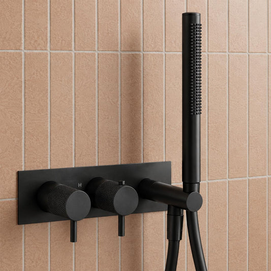 matte black wall-mounted shower system with two round control knobs and a handheld shower head 1200