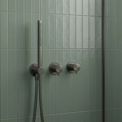 modern gunmetal shower fixture with a handheld showerhead and two control valves,