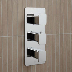 modern three-lever wall-mounted shower or bath control trim with a polished chrome finish