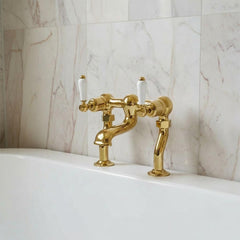 polished gold bridge tap with two white ceramic handles available in  Ireland 