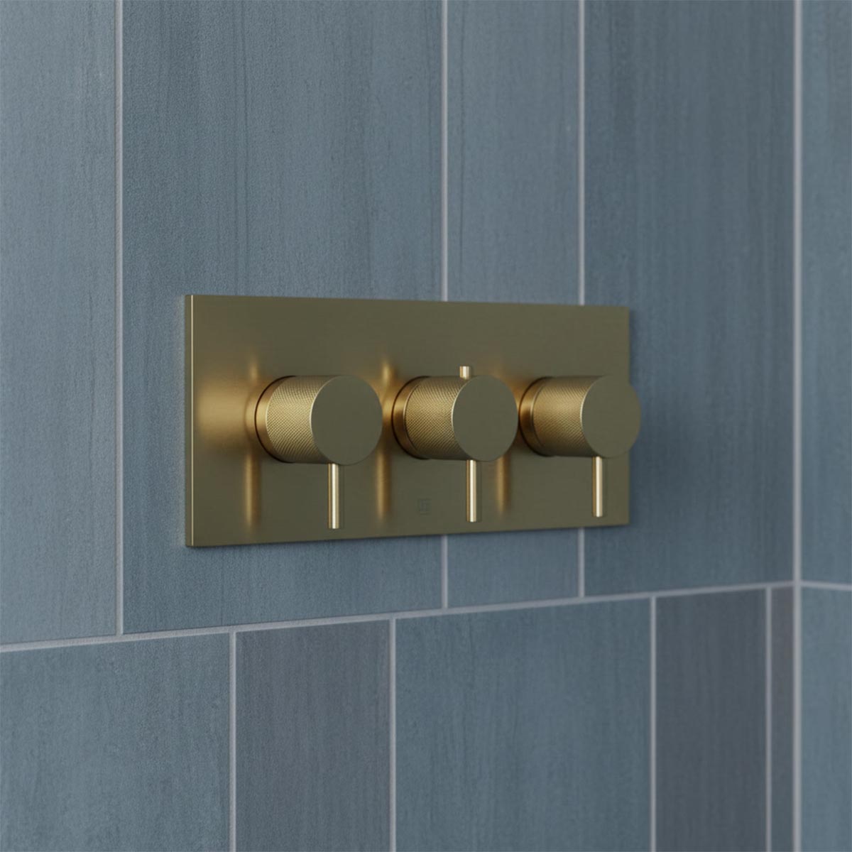 three-hole wall-mounted shower valve trim plate in brushed gold