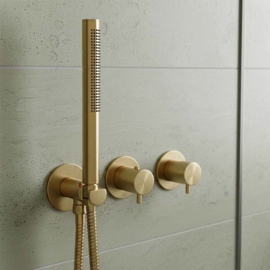 wall-mounted shower fixture in brushed gold, featuring a handheld shower head, flexible hose, and two round control valves in Ireland 1200